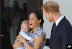 FILE - Prince Harry and Meghan, Duchess of Sussex, holding their son, Archie, in Cape Town, South Africa, on Sept. 25, 2019.