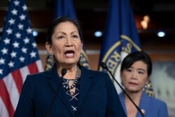 FILE - Congresswoman Deb Haaland, Native American Caucus co-chair, joined at right by Congresswoman Judy Chu, chair of the Congressional Asian Pacific American Caucus, speaks to reporters on Capitol Hill in Washington, March 5, 2020.