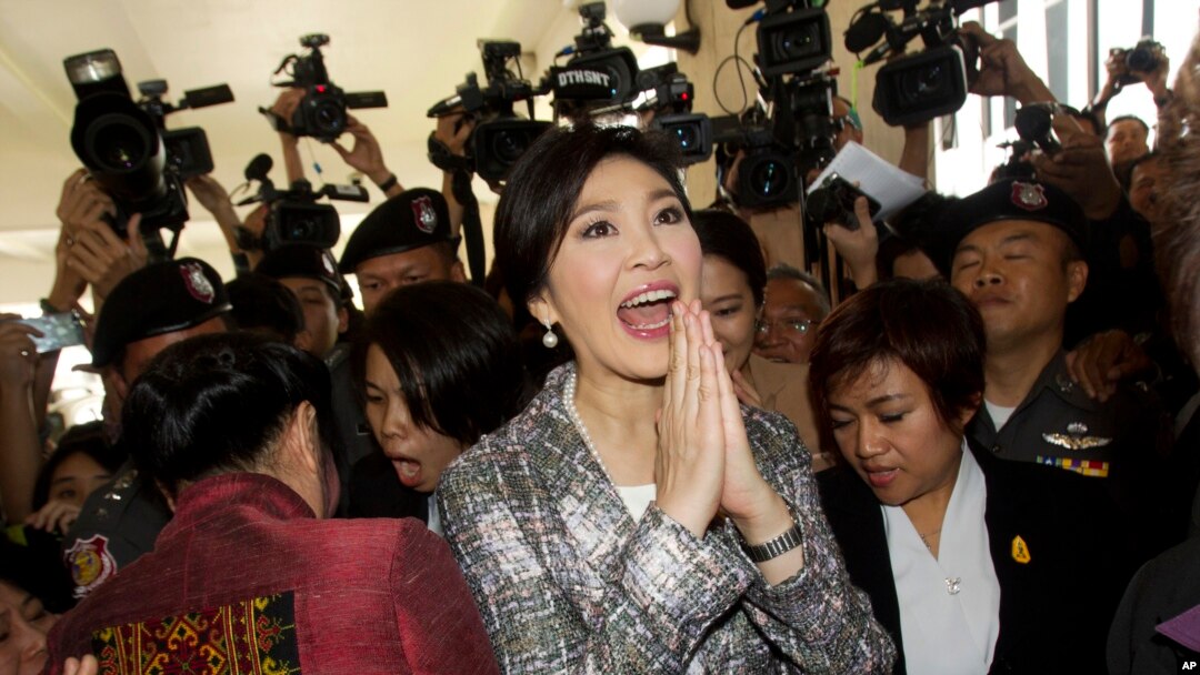 Mantan Perdana Menteri Thailand Yingluck Shinawatra (tengah) meninggalkan parlemen di Bangkok (22/1). (AP/Sakchai Lalit)