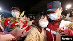 A medical team member hugs a family member at the end of a 14-day quarantine following the team's return from Wuhan, the epicentre of China's coronavirus disease (COVID-19) outbreak, at a hospital in Shanghai, China April 1, 2020.