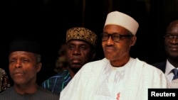 Nigeria's Vice President Yemi Osinbajo, President Muhammadu Buhari and International Monetary Fund Managing (IMF) Director Christine Lagarde look on in Abuja, Nigeria, January 5, 2016 REUTERS/Afolabi Sotunde - RTX213VH