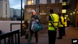 Residents are evacuated from the Taplow residential tower block on the Chalcots Estate, in the borough of Camden, north London, June 23, 2017. The evacuation, for safety concerns, followed a devastating fire that killed 79 people in a west London high-rise. 