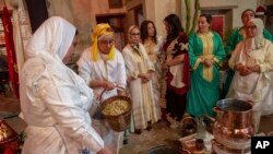 FILE — Women prepare to distill orange blossoms in a cultural center in Marrakech, Morocco, March 23, 2024. Moroccan cities are heralding in this year's spring with orange blossoms by distilling them using traditional methods. 