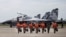 FILE - Indonesian Air Force Sukhoi fighter pilots and crew walk across the tarmac at the Hang Nadim Airport after training for an upcoming military exercise, Oct. 3, 2016.