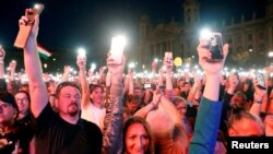 People attend a protest against the government of Prime Minister Viktor Orban in Budapest, Hungary, April 14, 2018. 