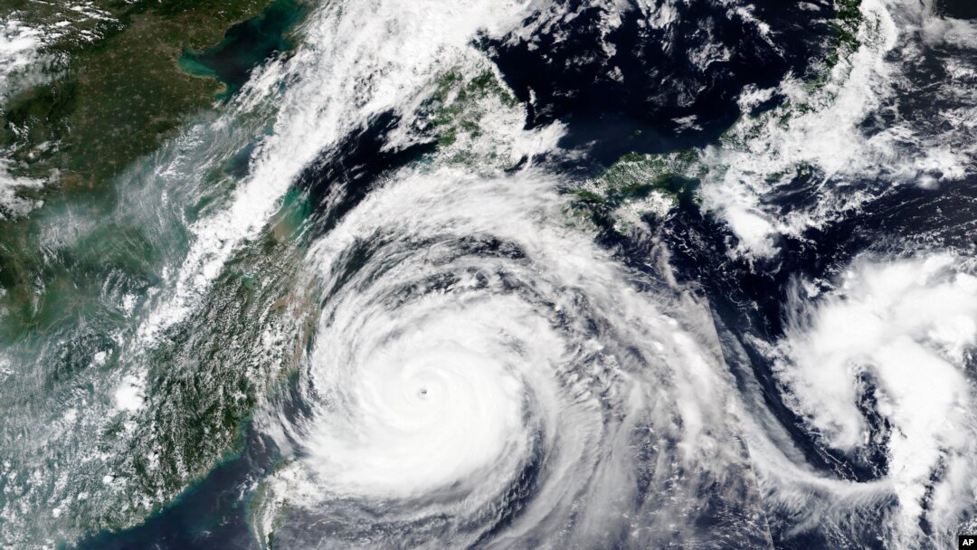 This Sept. 1, 2020, satellite image released by NASA shows Typhoon Maysak over Japan's southernmost islands, including Okinawa, center. 
