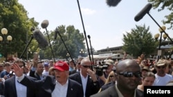 U.S. Republican presidential candidate Donald Trump greets attendees at the Iowa State Fair during a campaign stop in Des Moines, Iowa, United States, Aug. 15, 2015. 