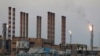 FILE - A general view of the Abadan oil refinery is seen in southwest Iran, from the Iraqi side, south of Basra, Iraq, Sept. 21, 2019.