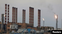 FILE - A general view of the Abadan oil refinery is seen in southwest Iran, from the Iraqi side, south of Basra, Iraq, Sept. 21, 2019.