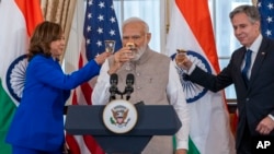 FILE - Vice President Kamala Harris, India's Prime Minister Narendra Modi, and Secretary of State Antony Blinken, share a toast during a State Visit Luncheon at the State Department, June 23, 2023, in Washington.