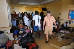 A man searches for his wife in the Marsh Harbour Medical Clinic in the aftermath of Hurricane Dorian on the Great Abaco island town of Marsh Harbour, Bahamas, Sept. 4, 2019.