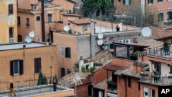 People clap their hands in appreciation for the efforts of Italian doctors and paramedics in Rome, Italy, March 14, 2020.