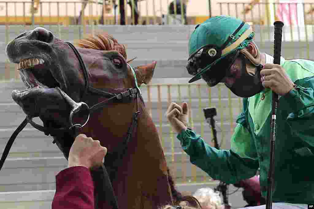 Jockey Cristian Demuro riding Sottsass celebrates after winning the Qatar Arc de Triomphe horse race at the Longchamp race track, outside Paris, France.