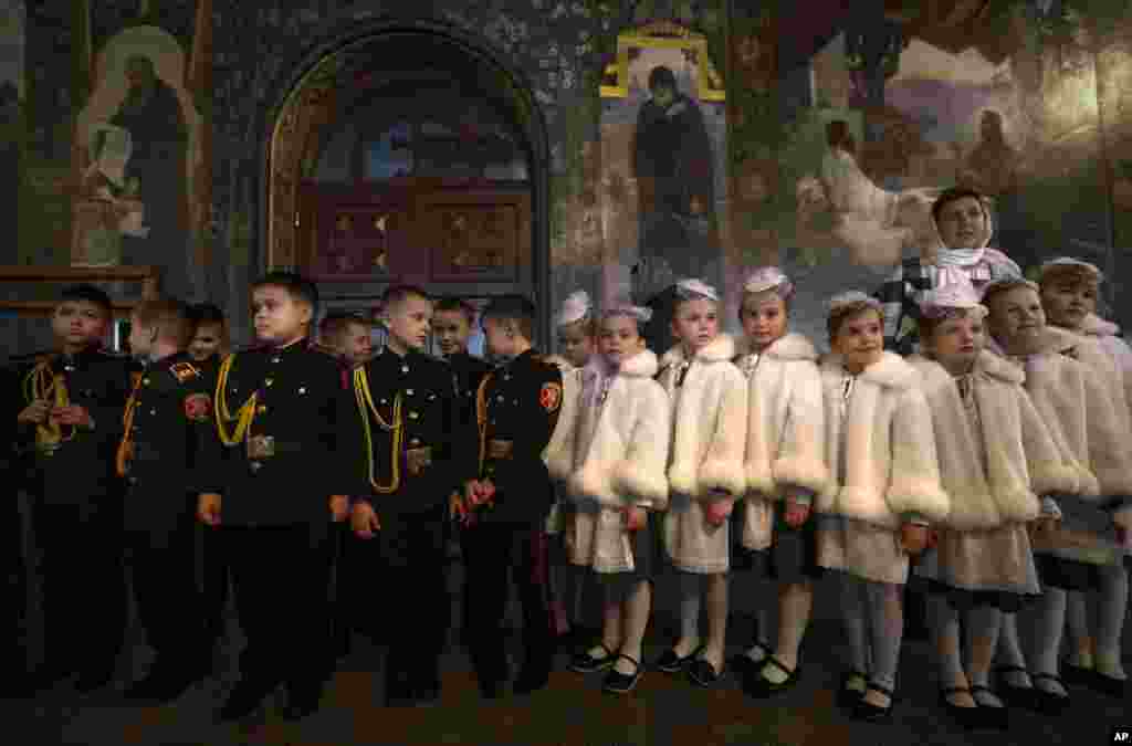 Ukrainian boys and girls dressed in cadet school uniforms, attend a swear-in ceremony in the Monastery of the Caves in Kiev.