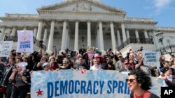 Demonstrators stage a sit-in at the Capitol in Washington, urging lawmakers to take money out of the political process, April 11, 2016.