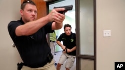 Trainees Chris Graves, left, and Bryan Hetherington, right, participate in a security training session at Fellowship of the Parks campus in Haslet, Texas, July 21, 2019.