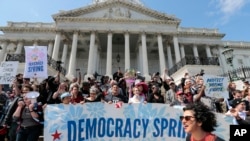 Demonstrators stage a sit-in at the Capitol in Washington, urging lawmakers to take money out of the political process, April 11, 2016.