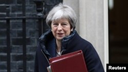 FILE - Britain's Prime Minister Theresa May leaves Downing Street after a meeting of the government's special COBRA committee in London, March 7, 2018.