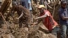 This undated handout photo taken by the UN Development Programme and released on May 28, 2024 shows locals digging at the site of a landslide at Mulitaka village in the region of Maip Mulitaka, in Papua New Guinea's Enga Province.