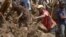 This undated handout photo taken by the UN Development Programme and released on May 28, 2024 shows locals digging at the site of a landslide at Mulitaka village in the region of Maip Mulitaka, in Papua New Guinea's Enga Province.
