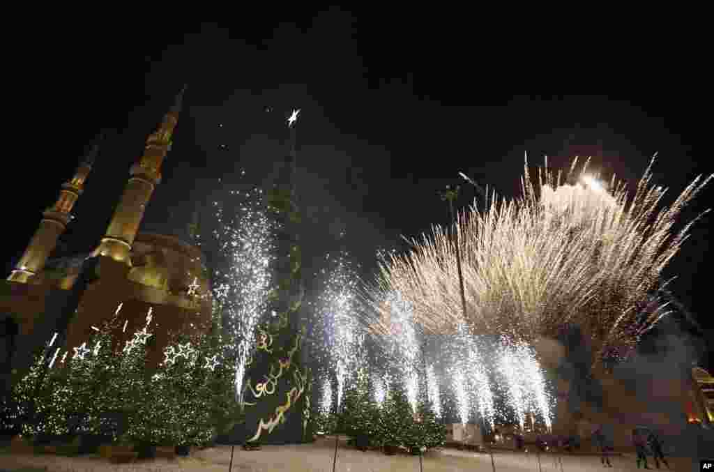 People watch fireworks during the illumination of a giant Christmas tree at the launch of 2015 Christmas Festivities in Beirut, Lebanon.