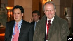 FILE - U.S. Assistant Secretary of State Christopher Hill, right, walks with Victor Cha, the U.S. National Security Council's director for Asian Affairs, before heading to six-party talks on North Korea's nuclear program, in Beijing, March 22, 2007.