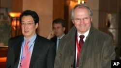 FILE - U.S. Assistant Secretary of State Christopher Hill, right, walks with Victor Cha, the U.S. National Security Council's director for Asian Affairs, before heading to six-party talks on North Korea's nuclear program in Beijing, March 22, 2007.