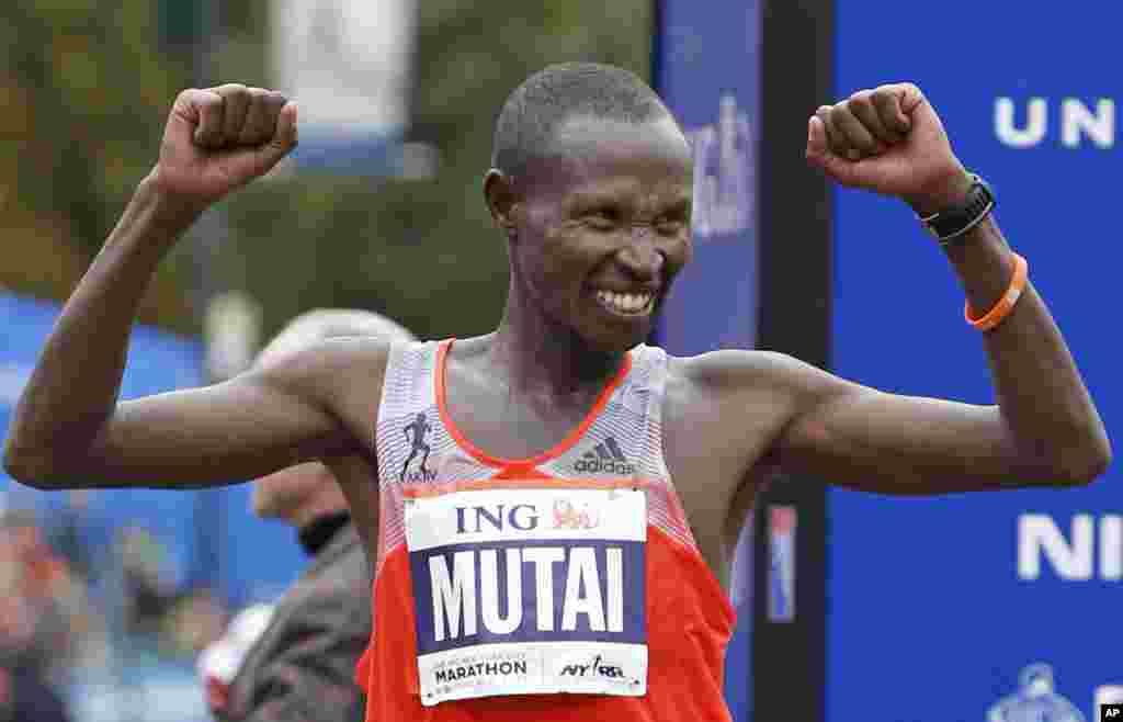 Geoffrey Mutai of Kenya celebrates his first place win in the men's division of the New York City Marathon, Nov. 3, 2013. 