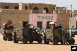 FILE - French Barkhane forces patrol the streets of Timbuktu, Mali, Sept. 29, 2021.