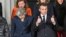 Prime Minister Theresa May (L) and French President Emmanuel Macron prepare for a group photo during UK-France summit talks at the Royal Military Academy Sandhurst, in Camberley, England, Jan. 18, 2018. 
