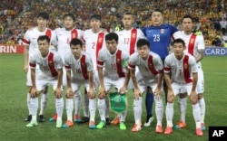 FILE - The Chinese team poses ahead of their AFC Asia Cup quarterfinal soccer match between China and Australia in Brisbane, Australia, Jan. 22, 2015.