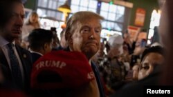 FILE - Former U.S. President and Republican presidential candidate Donald Trump rallies with supporters at a "commit to caucus" event at a Whiskey bar in Ankeny, Iowa, U.S. December 2, 2023.