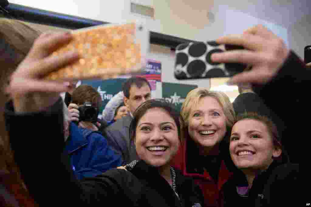 Democratic presidential candidate Hillary Clinton takes photos with workers at her campaign office in Des Moines, Iowa, Feb. 1, 2016.