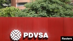 FILE - The corporate logo of the state oil company PDVSA is seen at a gas station in Caracas, Venezuela, Nov. 16, 2017.