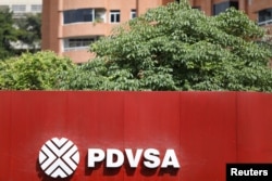 FILE - The corporate logo of the state oil company PDVSA is seen at a gas station in Caracas, Venezuela, Nov. 16, 2017.