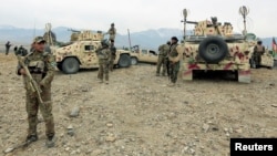 FILE - Afghan National Army troops prepare for an operation against insurgents in Khogyani district of Nangarhar province, Afghanistan, Nov. 28, 2017. 