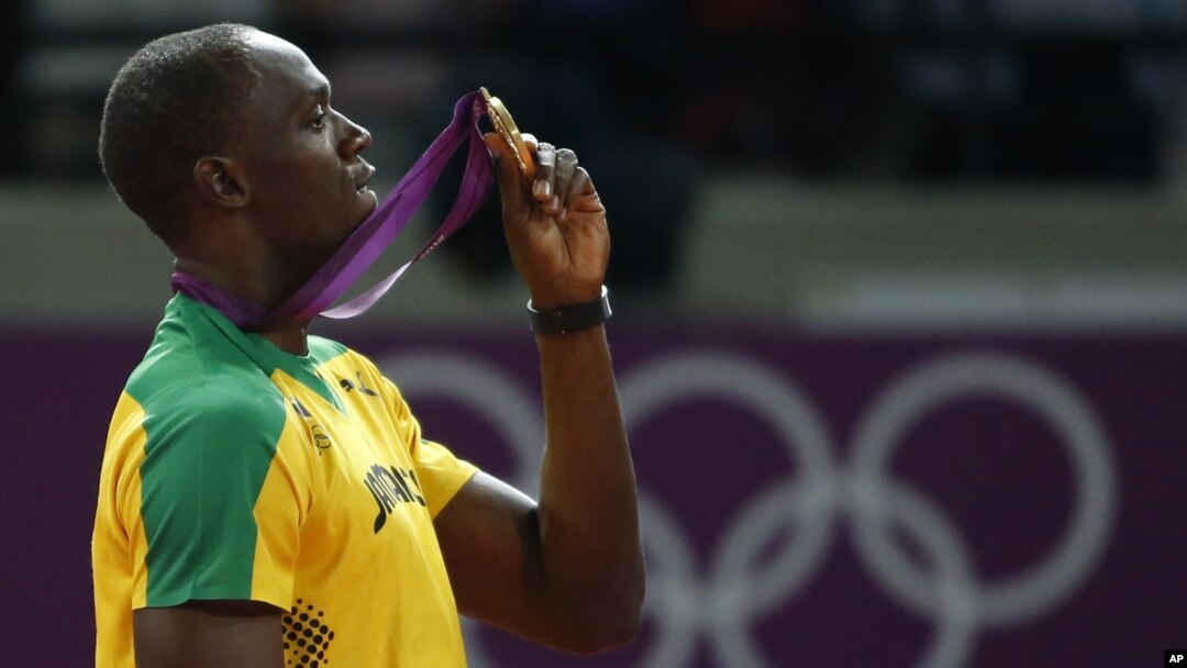 Pelari Jamaika, Usain Bolt, memegang medali emas yang diperolehnya setelah memenangkan cabang lari 200 meter di Stadion Olimpiade London (9/8). 
