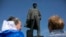 Pro-Russian activists stand in front of a monument of Soviet leader Vladimir Lenin during a rally in Donetsk, eastern Ukraine, April 27, 2014.