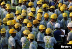 Construction workers from Bangladesh and India attend a briefing before starting work at a construction site in Singapore, March 24, 2016.