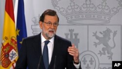 Spain's Prime Minister Mariano Rajoy gestures as he delivers a statement at the Moncloa Palace in Madrid, Oct. 11, 2017.