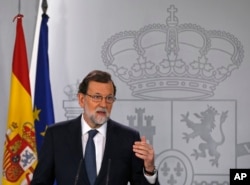 Spain's Prime Minister Mariano Rajoy gestures as he delivers a statement at the Moncloa Palace in Madrid, Oct. 11, 2017.