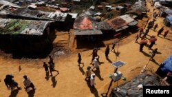 Rohingya refugees walk through the Kutupalong refugee camp area, near Cox’s Bazar, Bangladesh, Nov. 6, 2017.
