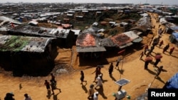 Rohingya refugees walk through the Kutupalong refugee camp area, near Cox’s Bazar, Bangladesh, Nov. 6, 2017.