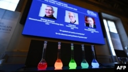 Laboratory flasks are used for explanation during the announcement of the winners of the 2023 Nobel Prize in chemistry at Royal Swedish Academy of Sciences in Stockholm on October 4, 2023. (Photo by Jonathan NACKSTRAND / AFP)