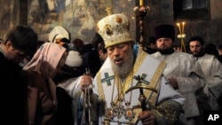 FILE - In this file photo taken Jan. 5, 2014, the head of the Ukrainian Orthodox Church under the Moscow Patriarchate, Volodymyr, foreground, leads services during the Christmas Eve mass in the Kyiv-Pechersk Lavra church in Kyiv.