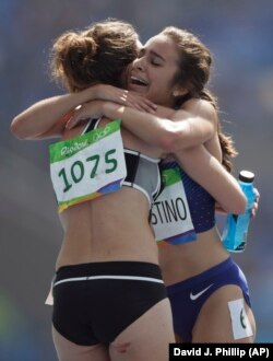 New Zealand's Nikki Hamblin, left, and United States' Abbey D'Agostino after competing in a women's 5000-meter heat