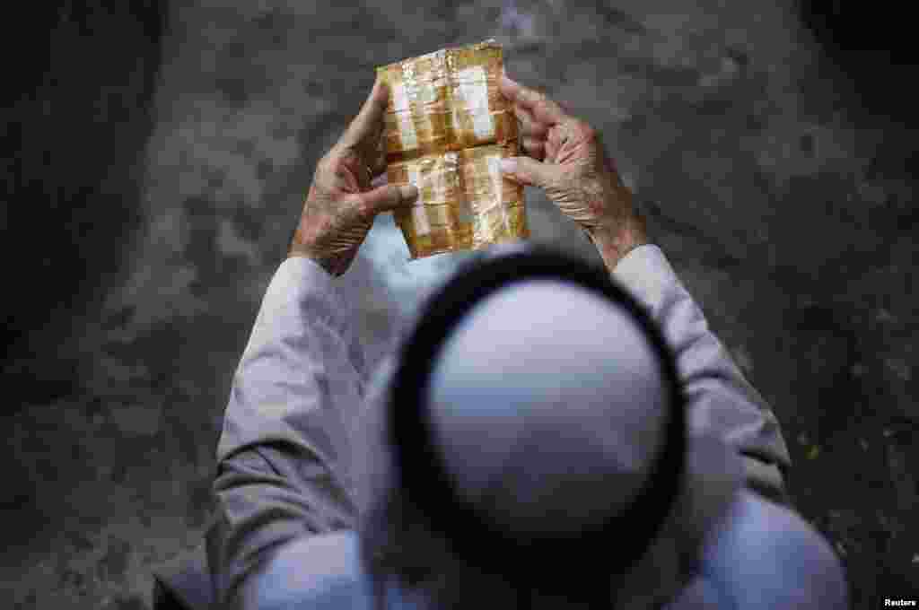 Palestinian refugee Khamis Redwan, 75, displays his birth certificate, which he has kept since he fled home, at Jabalya refugee camp in the northern Gaza Strip.