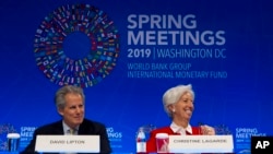 International Monetary Fund (IMF) Managing Director Christine Lagarde accompanied by Deputy Managing Director David Lipton, speak at a news conference, during the World Bank/IMF Spring Meetings in Washington, April 11, 2019.