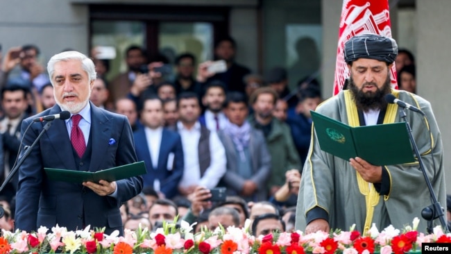 Afghanistan's former Chief Executive Officer Abdullah Abdullah and cleric Shahzada Shahid attend a swearing-in ceremony of Afghanistan's President Ashraf Ghani (not pictured), in Kabul, Afghanistan March 9, 2020.