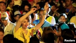 FILE - Geraldine Roman, a transgender congressional candidate, gestures at the crowd during a "Miting de Avance" (last political campaign rally) for the national election in Orani town, Bataan province, north of Manila, May 6, 2016. 